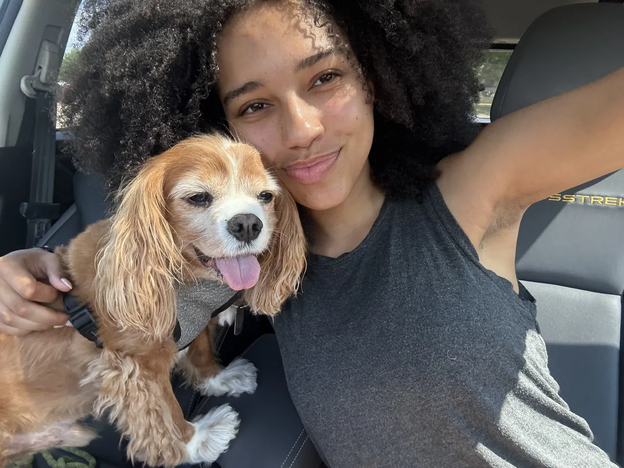 Aubrey smiling with a cocker spaniel